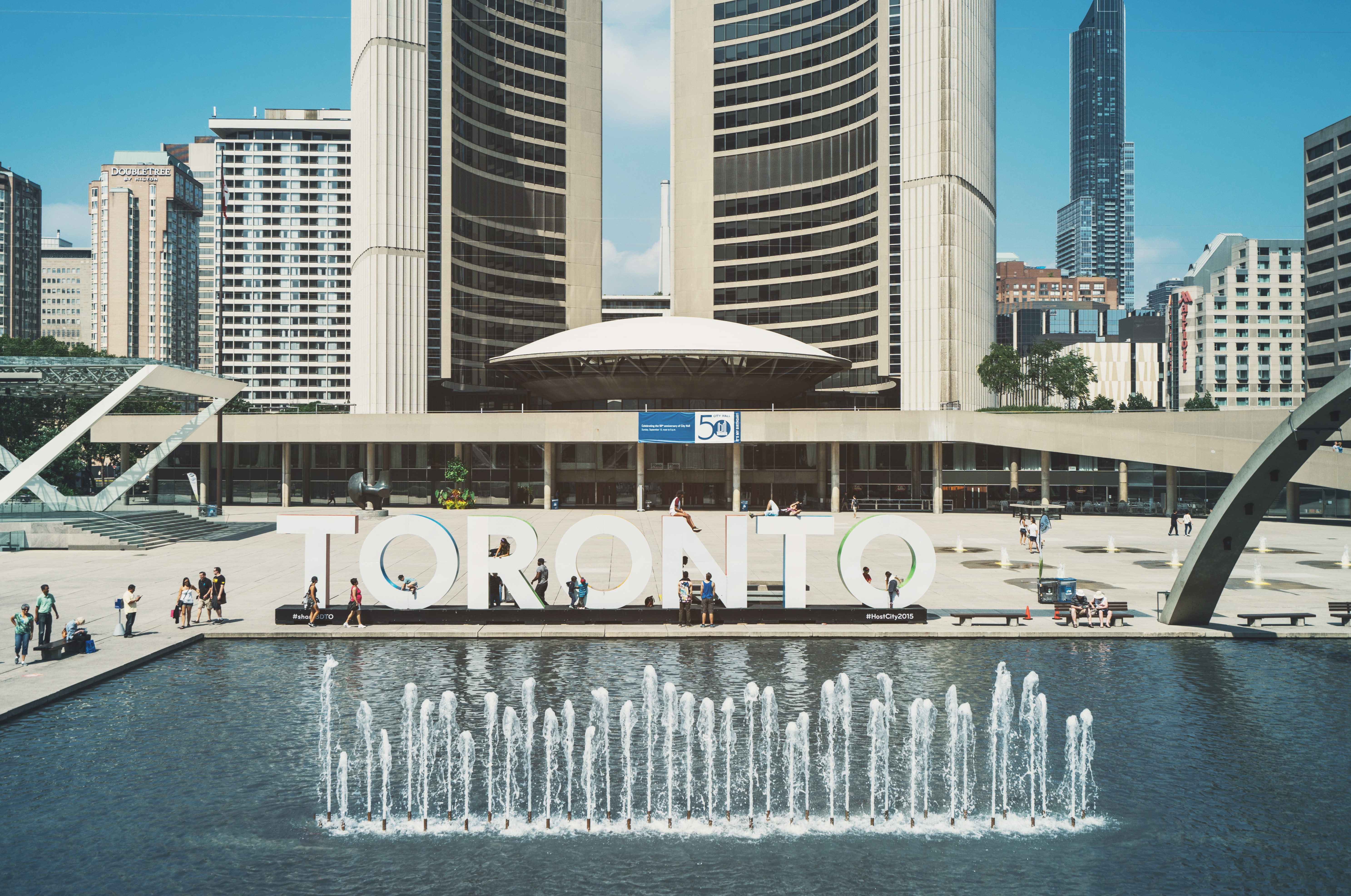 The Toronto sign behind a beautiful fountain piece